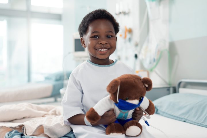 Digestive and Liver Congenital Disorders: Expert Pediatric Surgical Solutions Black child and teddy bear in hospital for pediatric surgery recovery, patient and healthy results.