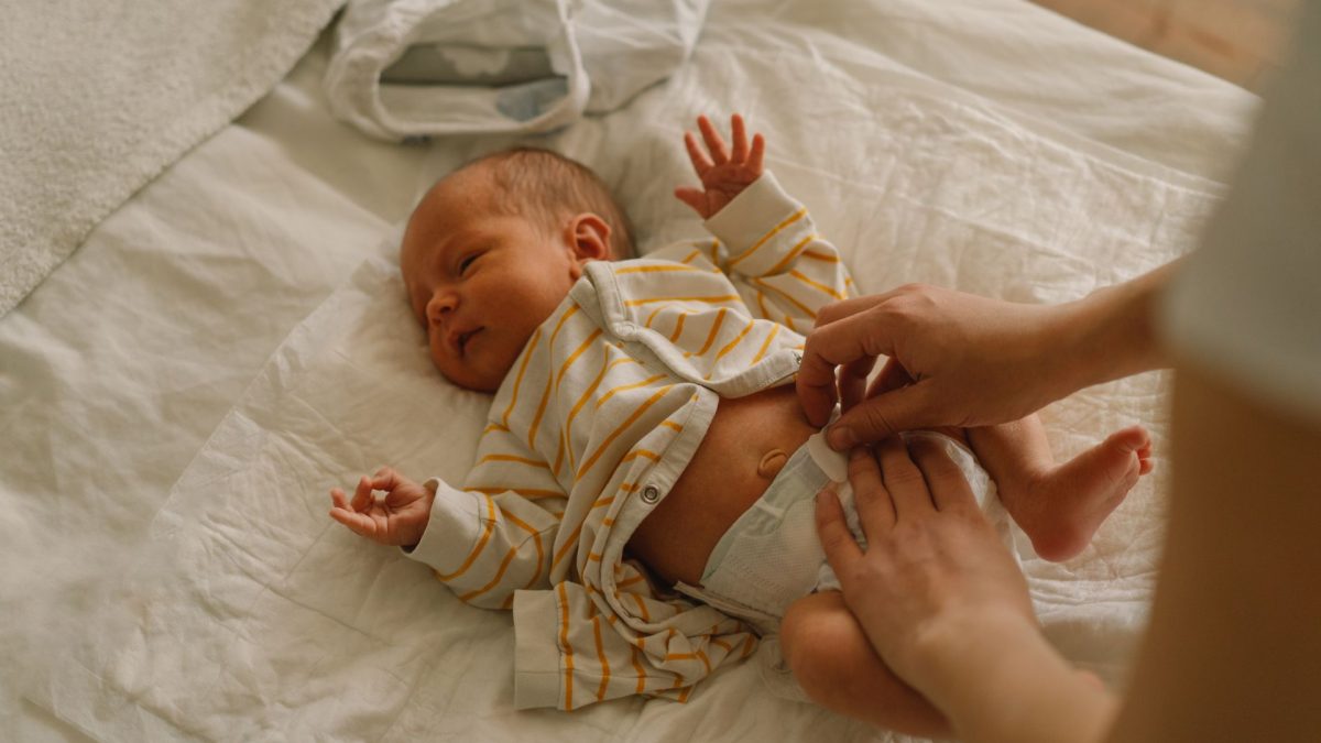 Baby being changed on a bed. Pediatric Colorectal Surgery