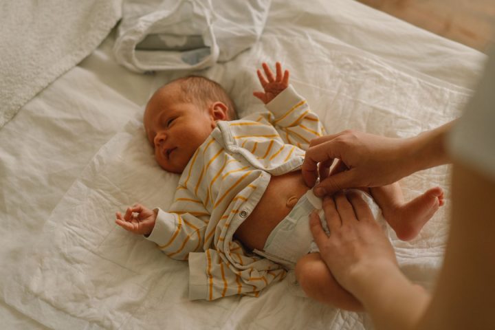 Baby being changed on a bed. Pediatric Colorectal Surgery